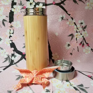 a bamboo cup and a teapot