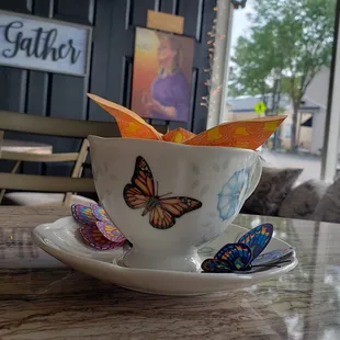 a cup of tea with butterflies on it