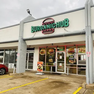 a red car parked in front of the store