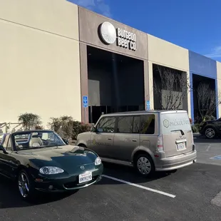 two cars parked in a parking lot