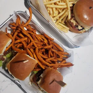 two trays of burgers and fries
