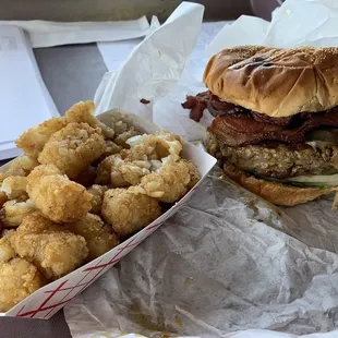 a plate of fried tater tots and a sandwich