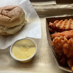 Double burger with American cheese and fried egg, sweet potato fries and honey mustard sauce.