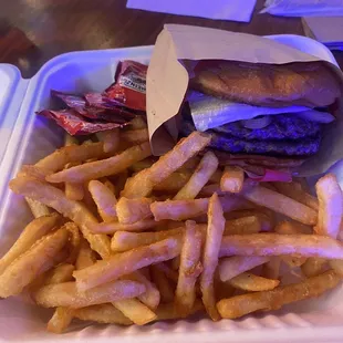 french fries and a sandwich in a styrofoam container