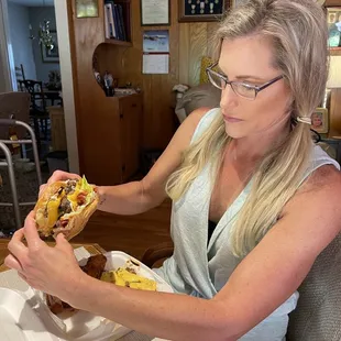 a woman eating a hot dog