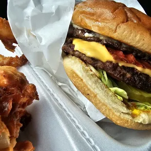 Double burger with cheese and bacon. Side of onion rings