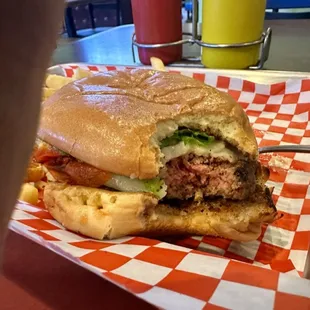 Weird bit burger view to show the thick, juicy hand-formed patty cooked to a nice medium.