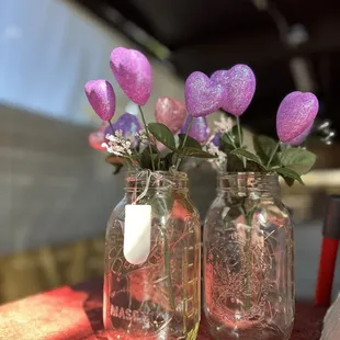 two jars with flowers in them