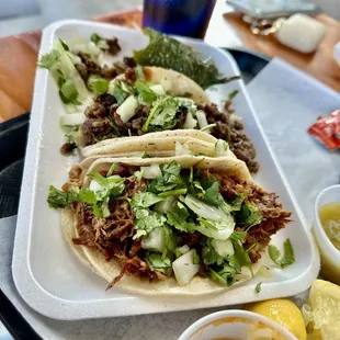 a plate of tacos and a drink