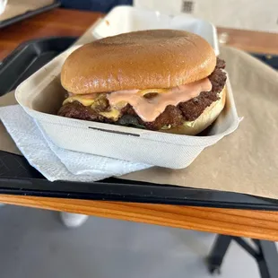 a hamburger in a styrofoam container