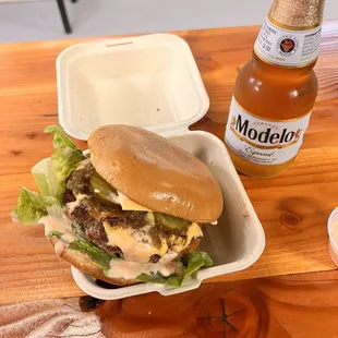 a burger and a beer on a table