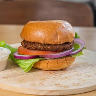 a burger with lettuce, tomato, onion, and mayo