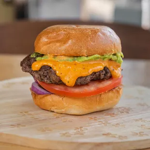 a cheeseburger on a wooden board