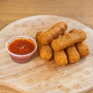 a plate of fried tater tots and ketchup