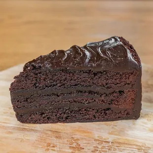 a slice of chocolate cake on a cutting board