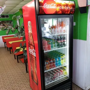 A refrigerated box with bottled drinks.