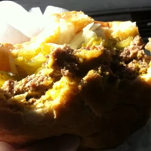 a person holding a sandwich in their hand