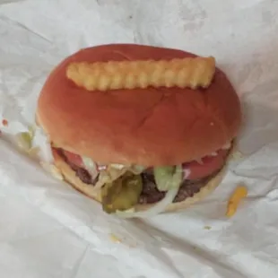 a hamburger with french fries on it