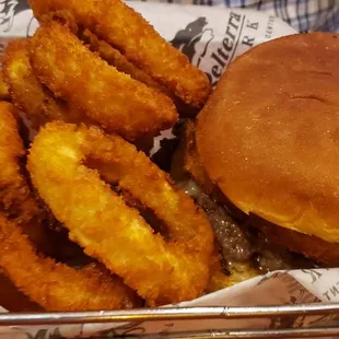 a basket of onion rings and a burger
