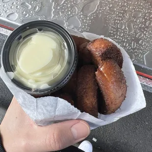 a person holding a bowl of dip