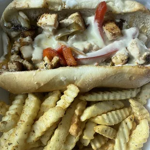 a hot dog and french fries in a styrofoam container