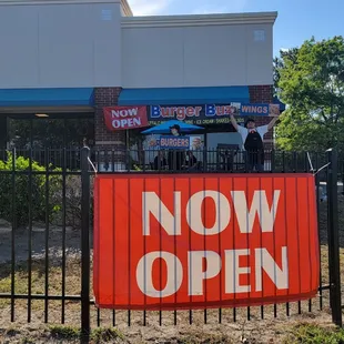 a now open sign in front of a restaurant