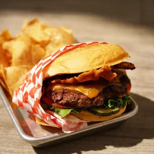 Bacon cheddar burger with taro root chips.  Photo by Vivian Leba.