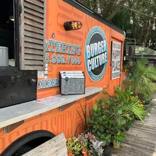 an orange food truck parked in front of a building
