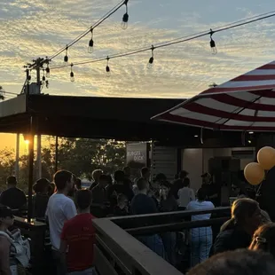 a crowd of people at sunset