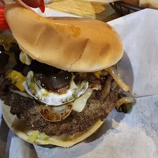 a hand holding a hamburger