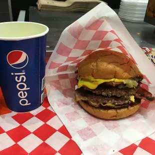 a burger and a drink on a table