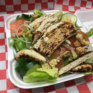 a chicken salad with lettuce and tomatoes