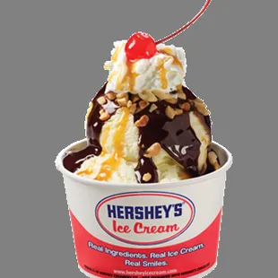 a cup of ice cream with a cherry on top