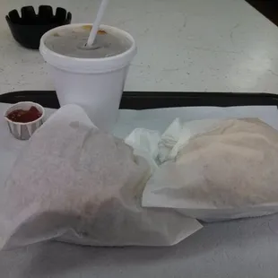 a sandwich and drink on a tray