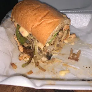 a half eaten sandwich in a styrofoam container