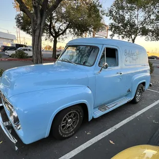 a blue truck parked in a parking lot