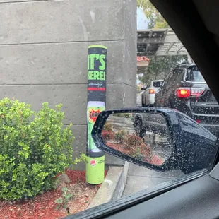 it's here sign on a parking meter