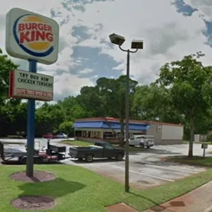 a parking lot with cars parked in front of it