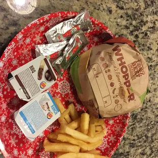a plate of fries and a bag of chips