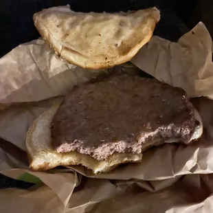 a burger on a piece of brown paper