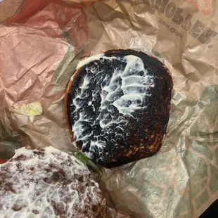 a half eaten sandwich and half eaten donut