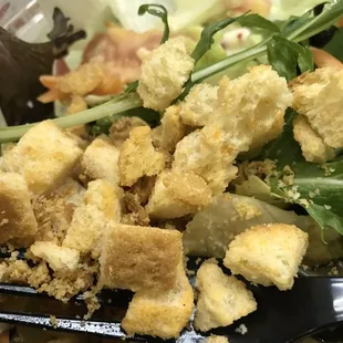 a salad with croutons and lettuce