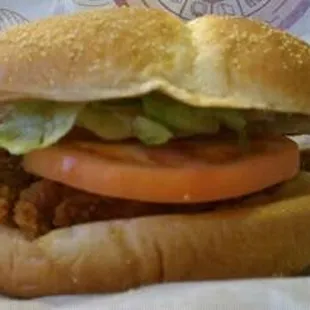 a chicken sandwich with lettuce, tomato, and lettuce