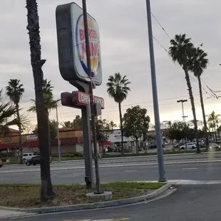 a street corner with palm trees