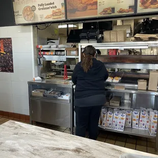 a woman standing in front of a counter