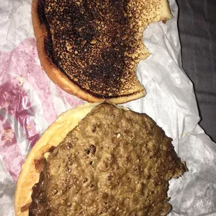two burgers on a piece of wax paper