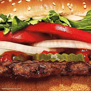 a beef sandwich with lettuce, onions, and peppers