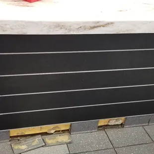Tiles falling off the counter.