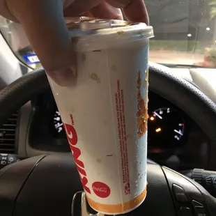 a hand holding a cup of coffee