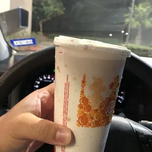 a hand holding a cup of coffee